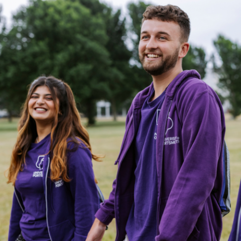 Student ambassadors wearing purple University of Portsmouth tops and smiling