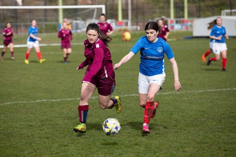 Women football players on a pitch