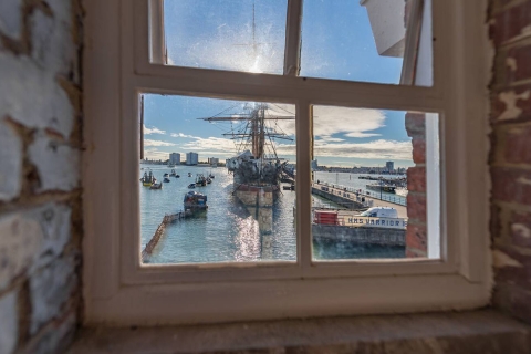 HMS Warrior seen through a window in Portsmouth Historic Dockyard