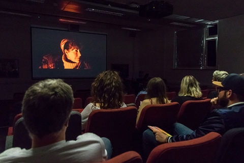 cinema screening room with film playing