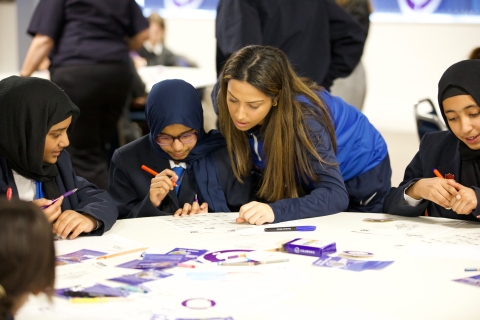 Portsmouth FC Women's player Anisha Hill with student at Treasure Your Chest workshop