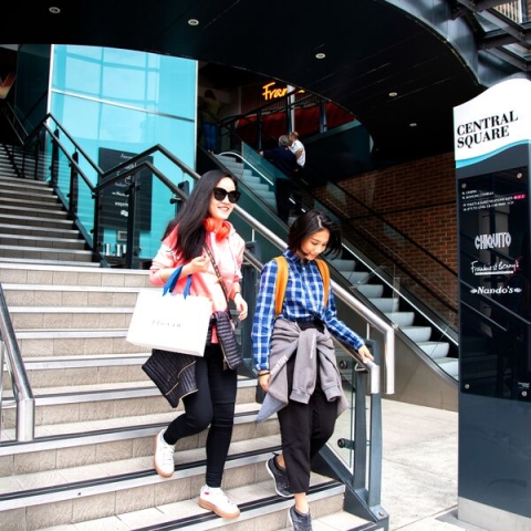 two women with shopping bags in gunwharf quays