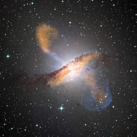 Composite of visible, microwave and X-ray data reveals the jets and radio-emitting lobes emanating from Centaurus A's central black hole
