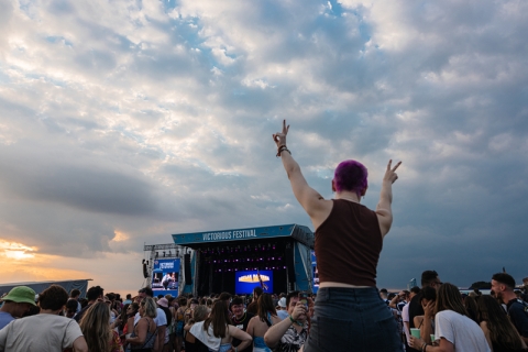 Festival-goer standing and giving victory sign - Victorious Festival