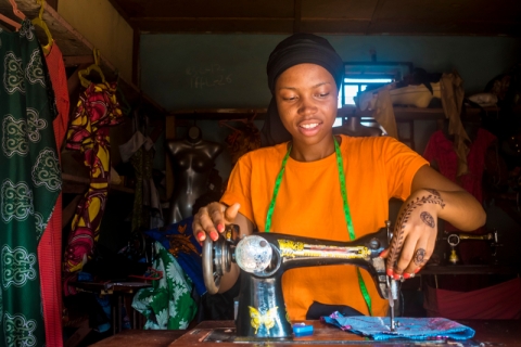 Young African female tailor working