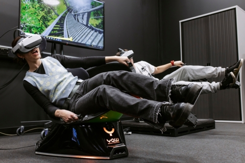 people seated on Virtual reality equipment experiencing a virtual reality performance