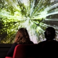 people in a theatre, watching a film