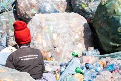 A person sorting plastic waste © James Wakibia