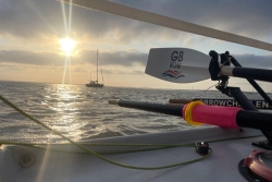 A sunset at sea with a GB Row Challenge oar in the foreground
