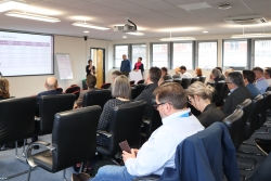 A staff member speaking to a room of people