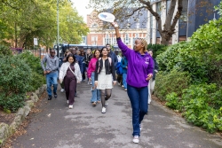 A Student Ambassador is leading a group of new students on a tour of the City