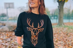 Picture of Lauren Steadman wearing black festive jumper with gold stag surrounded by leaves smiling