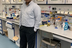 Image of Dr Binuraj Menon standing in a lab