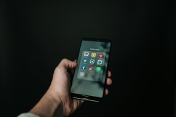 Photo of Hand Holding a Black Smartphone