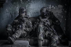 Two soldiers sitting down against a wall - Photo by Specna Arms on Unsplash