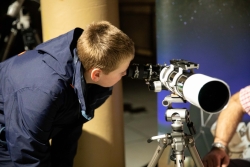 Child looking through telescope at Stargazing Event 2023.
