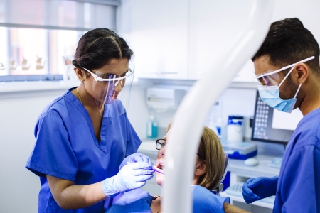 Dental nurses treating patient