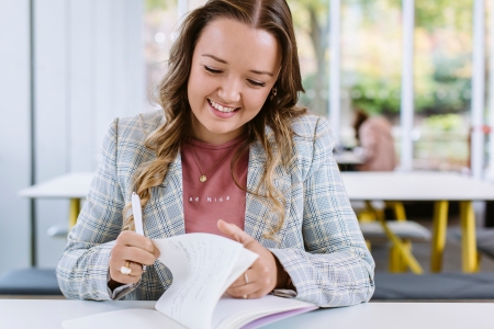 Student writing notes
