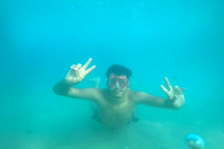 male swimming underwater