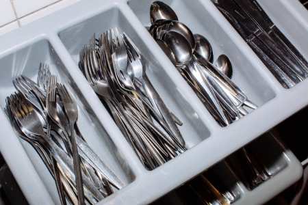 Silver eating utensils in a tray