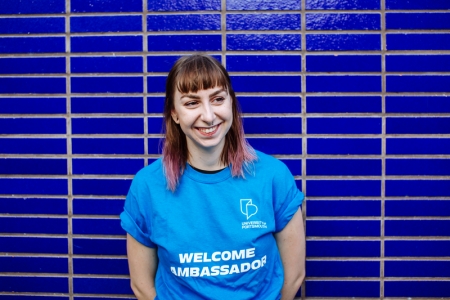 Ainhoa Robeck smiling in blue 'Welcome Ambassador' shirt