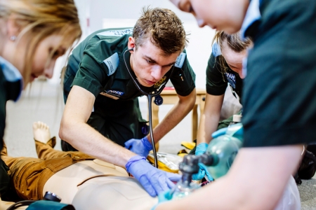 Paramedic students practicing on a manikin