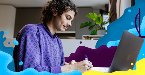 Male student sat at his desk wearing a purple jumper, it is Clearing