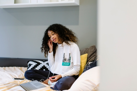 Student on bed in halls